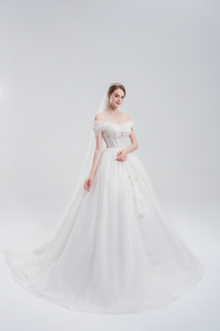 
Off-the-shoulder ball gown wedding dress with sparkling tulle, beaded bodice, and voluminous skirt for a romantic, princess-inspired bridal look