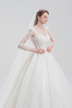 Load image into Gallery viewer, Long sleeve ball gown wedding dress with sparkling tulle, intricate beadwork, and a voluminous skirt for an elegant, romantic bridal look
