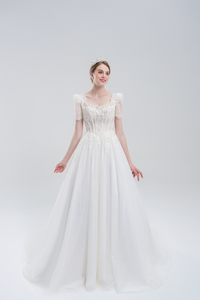 Elegant A-line wedding dress with lace puff sleeves, beaded bodice, and sparkling tulle skirt for a romantic, vintage-inspired bridal look