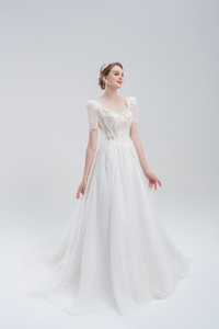 Elegant A-line wedding dress with lace puff sleeves, beaded bodice, and sparkling tulle skirt for a romantic, vintage-inspired bridal look