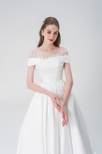 Elegant A-line wedding dress with off-the-shoulder design, satin fabric, intricate bead embellishments, and flowing skirt for a graceful silhouette