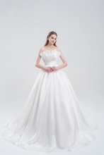 Load image into Gallery viewer, Strapless ball gown wedding dress in luxurious organza with a voluminous skirt, structured bodice, and ethereal layers for a romantic bridal look.
