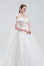 Load image into Gallery viewer, Off-the-shoulder ball gown wedding dress with sparkling tulle, intricate beadwork, and a voluminous skirt for a glamorous fairytale look.

