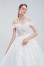 Load image into Gallery viewer, Off-the-shoulder ball gown wedding dress with sparkling tulle, intricate beadwork, and a voluminous skirt for a glamorous fairytale look.
