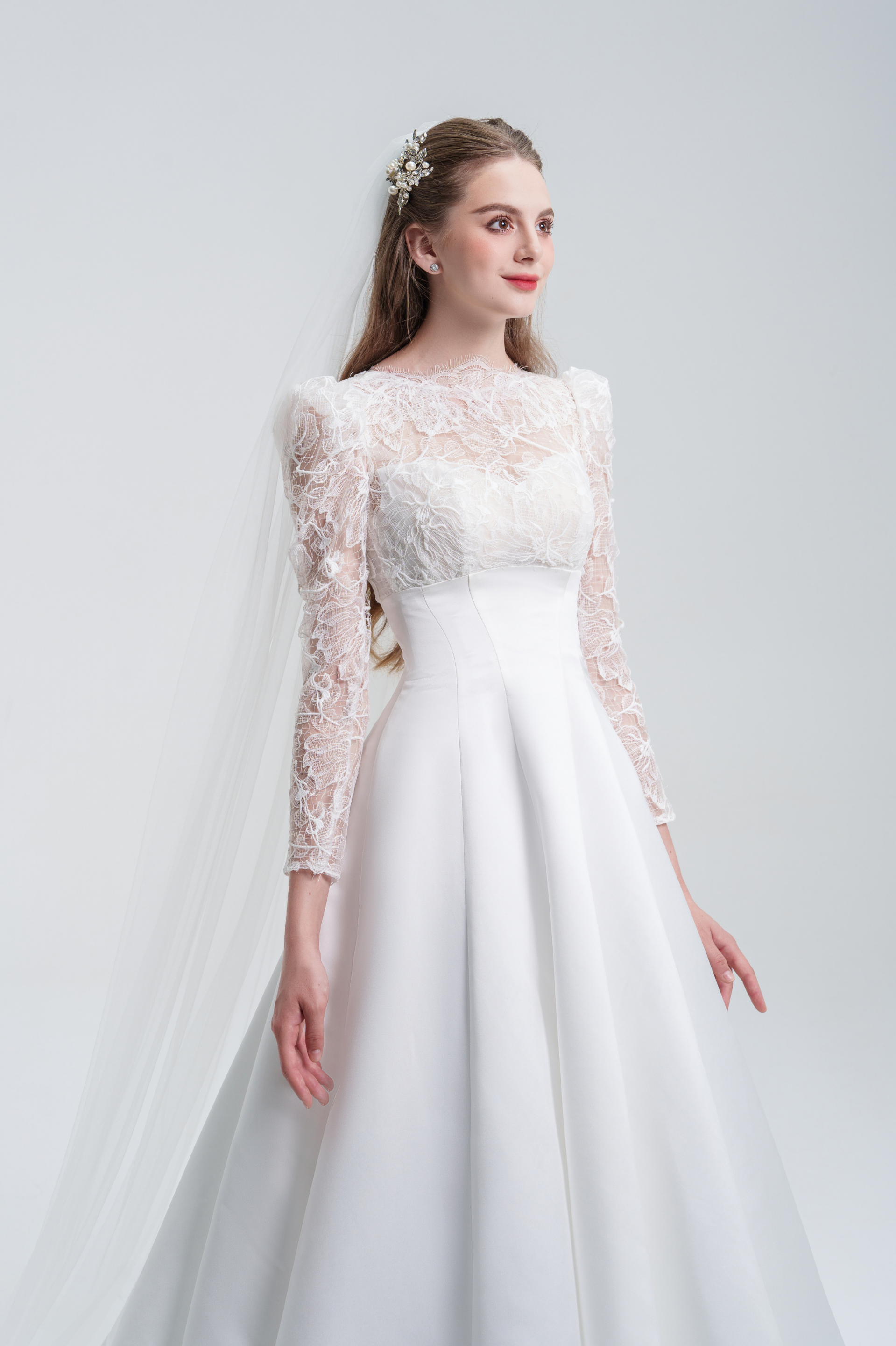 A stunning A-line wedding dress with long sleeves, flowing silhouette, soft fabric, and timeless elegance, perfect for modern and classic brides