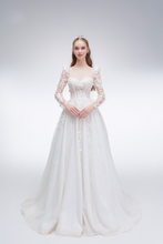 Load image into Gallery viewer, 
Romantic A-line wedding dress with sheer sleeves, leaf embellishments, sparkling fabric, and beaded details for an ethereal bridal look
