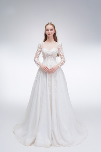 
Romantic A-line wedding dress with sheer sleeves, leaf embellishments, sparkling fabric, and beaded details for an ethereal bridal look