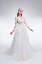 Load image into Gallery viewer, 
Romantic A-line wedding dress with sheer sleeves, leaf embellishments, sparkling fabric, and beaded details for an ethereal bridal look
