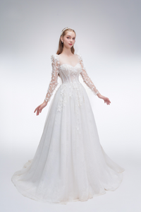 
Romantic A-line wedding dress with sheer sleeves, leaf embellishments, sparkling fabric, and beaded details for an ethereal bridal look