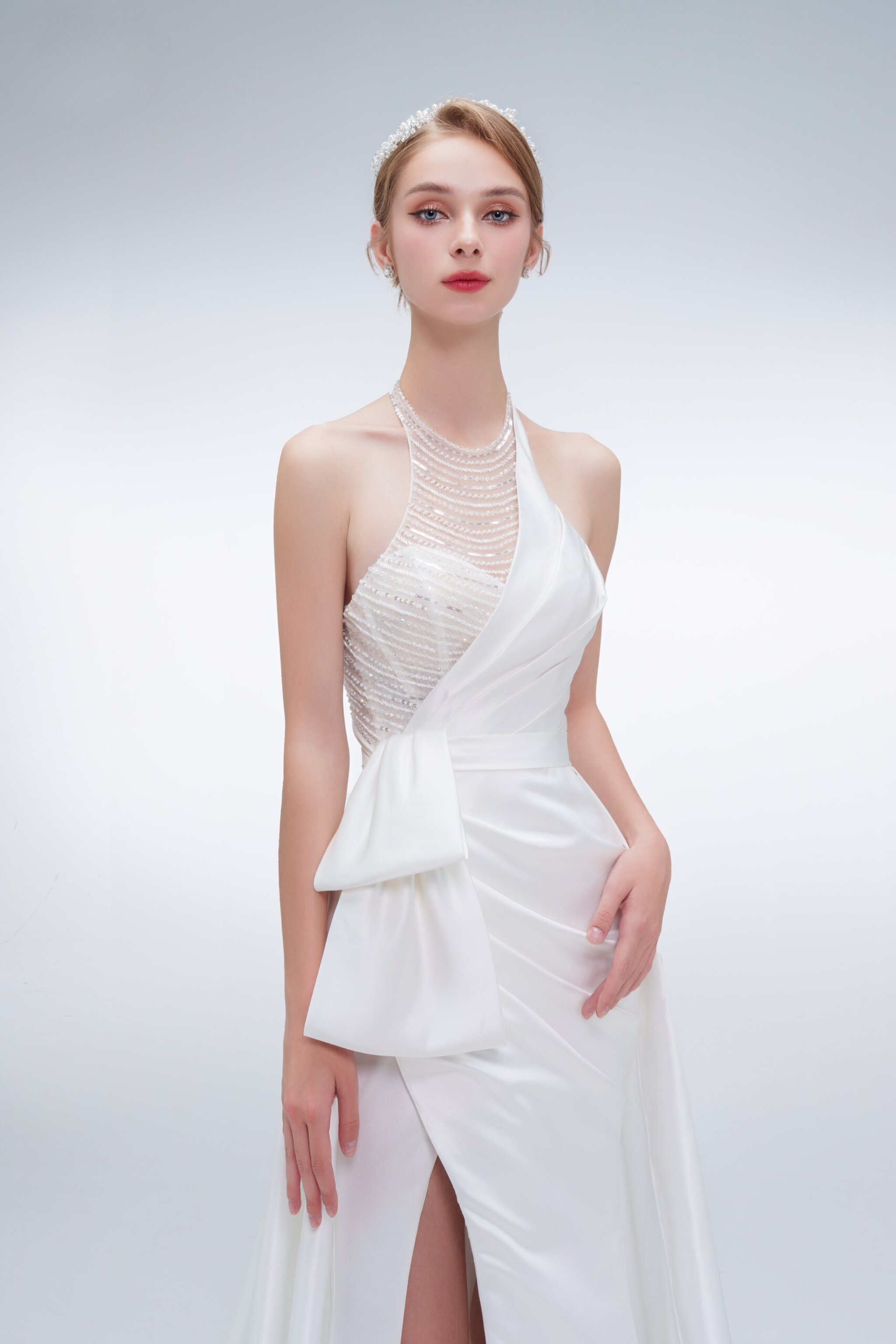 Elegant mermaid wedding dress with halter neckline, beaded details, high slit, and long train – modern bridal gown