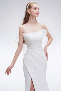 Strapless mermaid wedding dress with bead embroidery, satin-organza fabric, and high leg slit for a glamorous bridal look